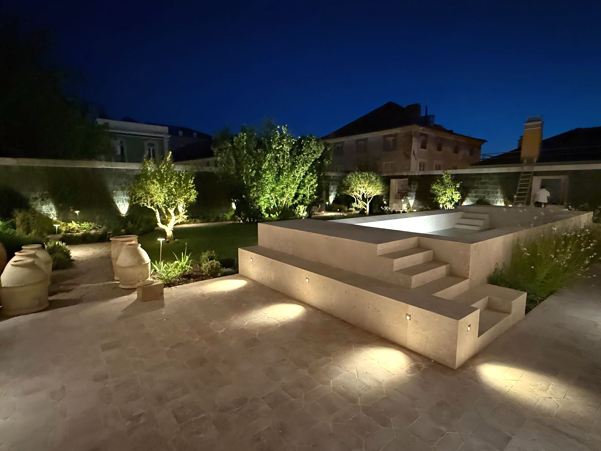 A pool terrace and its steps lit at night