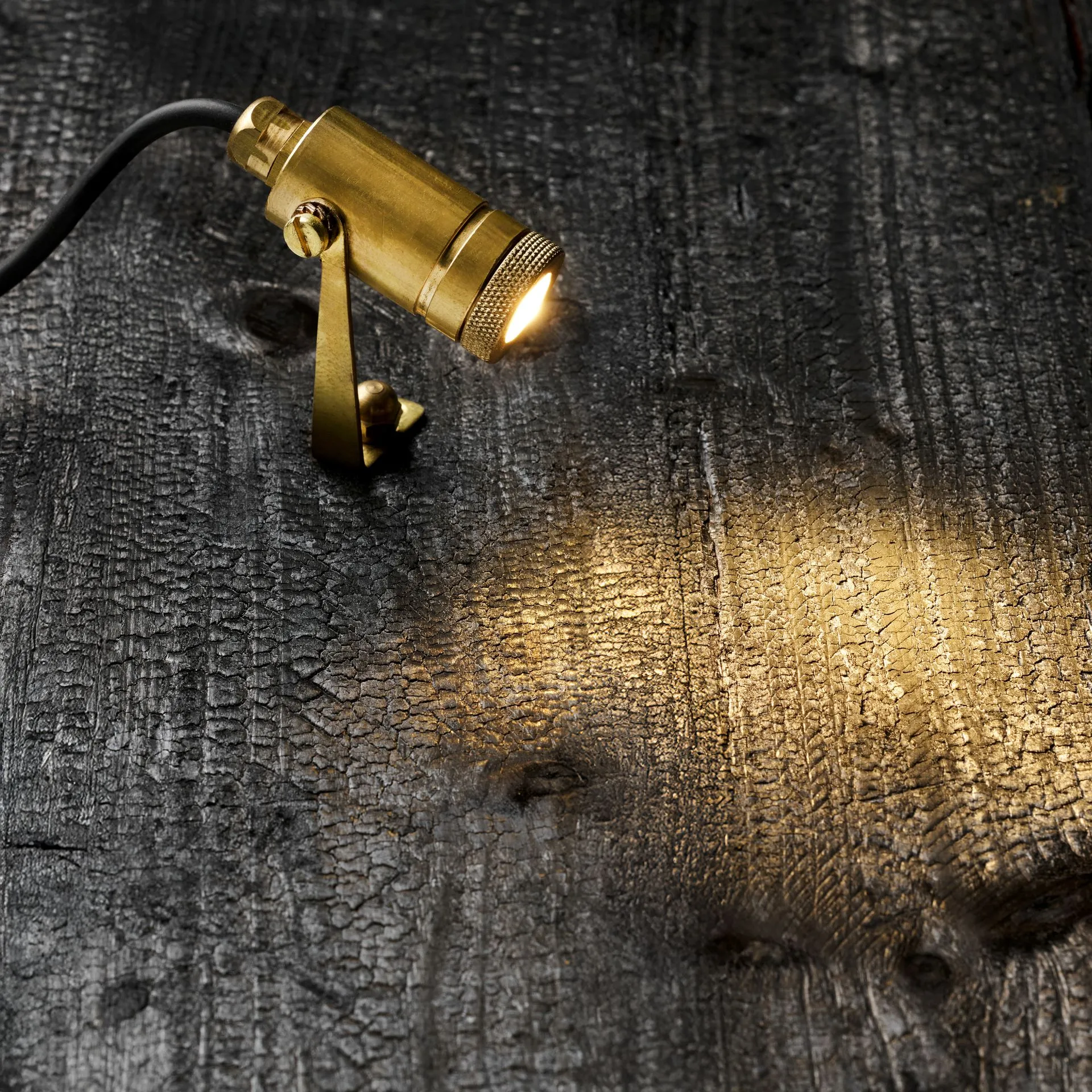 Zapa Native Yoke, solid brass, on burnt wood, photo 1